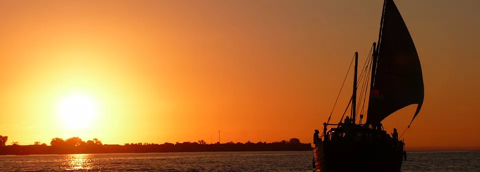 dhow sailing at sunset
