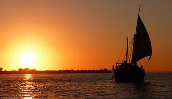 dhow sailing at sunset dhow sailing at sunset